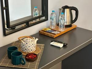 a table with a kettle and cups and water bottles at The Independent Hotel Taksim in Istanbul