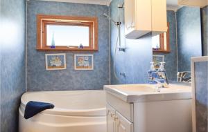 a bathroom with a toilet and a sink at 4 Bedroom Gorgeous Home In Hervik in Hervik
