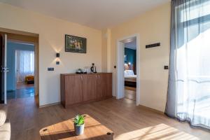 a living room with a table and a bedroom at Simada Center Guesthouse in Varshets