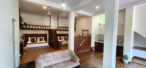 a room with two bunk beds and a couch and a chair at Poomaz Peace Palace in Ella +91 photos
