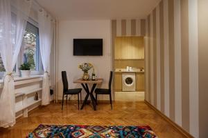 a living room with a table and a kitchen at Best choice Hram centar in Belgrade