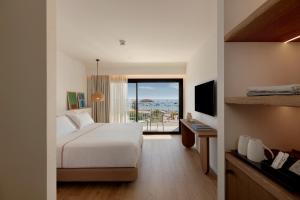 a hotel room with a bed and a balcony at Elisabeth by the Sea Hotel in Tossa de Mar