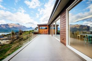 a house with a view of the mountains at Amazing lake view ensuite #1& floor heating in Queenstown