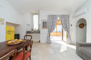 a kitchen and dining room with a table and chairs at Torre del Califfo Amalfi Relais in Amalfi