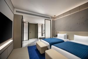 Voodi või voodid majutusasutuse Vance Hotel - Alibaba Xixi C District toas