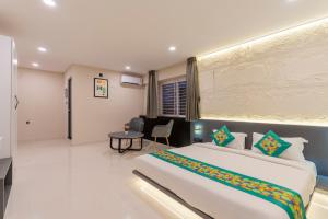 Voodi või voodid majutusasutuse Treebo Sanmaya Retreat, 15 Mins From Mysore Palace toas