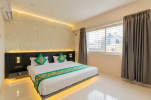 Voodi või voodid majutusasutuse Treebo Sanmaya Retreat, 15 Mins From Mysore Palace toas