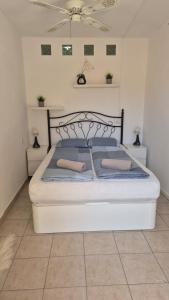 a bedroom with a bed with blue pillows at Apartment Puerto de Santiago in Puerto de Santiago +9 photos