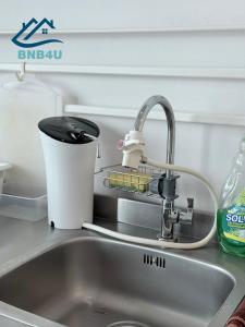a kitchen sink with a faucet next to a sink at Duplex Seaview Comfort Stay in City By IZ in George Town