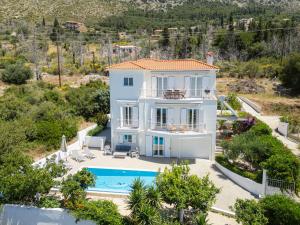 an aerial view of a villa with a swimming pool at The Garden House Ionian Panorama & Infinity Pool in Lourdata
