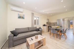 a living room with a couch and a table at Lakithra Comfort Cove in Lakithra