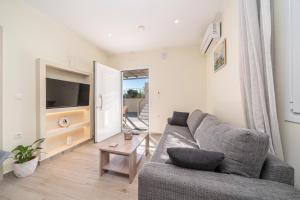 a living room with a couch and a television at Lakithra Comfort Cove in Lakithra