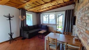 a living room with a table and a couch at MiłoRyn in Ryn