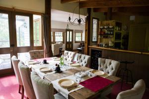 a dining room with a wooden table and chairs at Buttercup Hill in Warburton