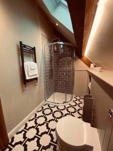 a bathroom with a shower and a toilet in it at Cuckoo Penn Hideaway - Luxury Cotswold Retreat in Gloucestershire +55 photos