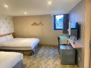 Postel nebo postele na pokoji v ubytování Jin Tsai Shen Hotel