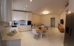 a kitchen and dining room with a table and chairs at White Dome Apartment I in Souda