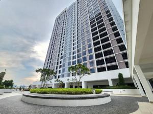 a tall white building with a large building at Veranda Residences by Cactus Homestay THM in Johor Bahru