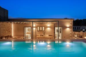 a swimming pool in front of a house at night at River Serenity Villa Vryses - Private Pool in Vryses