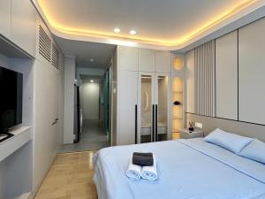 Postel nebo postele na pokoji v ubytování HOD Apartment Tan Dinh