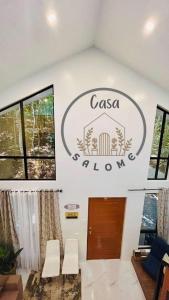 a sign on the wall of a room with chairs at Tagaytay's Cozy Loft-type Forest House and Camp in Silang +48 photos