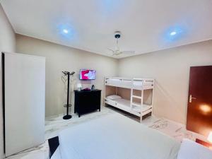 a room with a bed and a tv on a ceiling at APT Umi 22 in Linate
