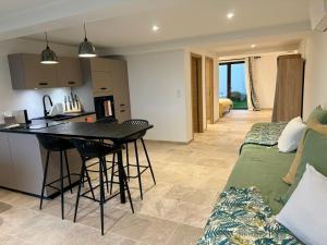 a kitchen and living room with a table and chairs at Domaine LUMISTELLA in Porticcio