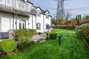 a house with a yard with green grass at Snowdonia View in Llanfairpwllgwyngyll
