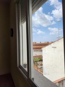 a window with a view of a building at Villalucen in Lucena