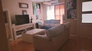 a living room with a couch and a tv at Villalucen in Lucena