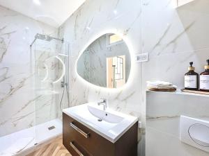 a white bathroom with a sink and a mirror at DELUXE SEAVIEW BALCONY - 2 min PALAIS & BEACH in Cannes +21 photos