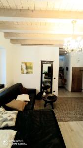 a living room with a black couch and a table at CASA Siloah in San Martino della Battaglia +28 photos