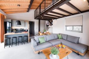 a living room with a couch and a table at Villa Angelou Nidri by Villa Plus in Nydri