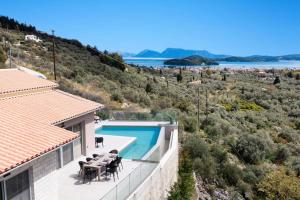 a villa with a swimming pool and a view at Villa Angelou Nidri by Villa Plus in Nydri