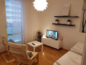 a living room with a tv and a couch at Kotimaailma - Studio with sauna in center in Turku