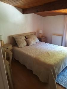 a bedroom with a bed with two night stands and two tables at Maison prés d'Agen in Bon-Encontre