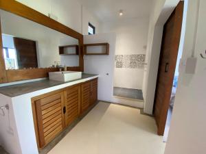 a bathroom with a sink and a mirror at COCO MANGO Villa in Trèfles