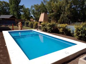 a swimming pool in a yard with a house at Espejos de monte in San Miguel del Monte