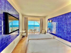 a hotel room with a bed and a view of the ocean at Perla Marina in Nerja