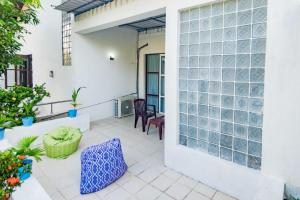 a patio with glass doors and chairs and plants at Hotel One Sixty in Dehiwala