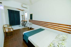 a bedroom with a bed and a table and chairs at Hotel One Sixty in Dehiwala +43 photos