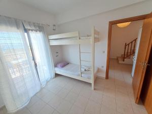 a room with two bunk beds and a staircase at Almyrida Beach Bungalow Sea Front in Chania