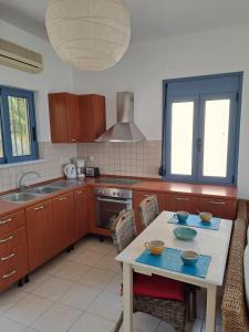 a kitchen with a table with bowls on it at Almyrida Beach Bungalow Sea Front in Chania