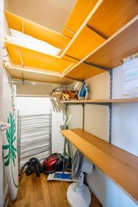 a room with a desk and a surfboard at Montparnasse - Vue Tour Eiffel - Balcon in Paris