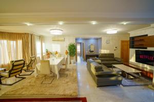 a living room with a couch and a table and chairs at Cozy apartment with stunning view near TGV station in Tangier