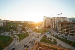 a view of a city with cars on a street at Cozy apartment with stunning view near TGV station in Tangier
