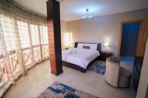 a bedroom with a bed and a large window at Cozy apartment with stunning view near TGV station in Tangier