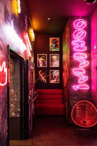 a room with a staircase with neon signs on the wall at SO City Hotel Adults Only in St. Julianʼs