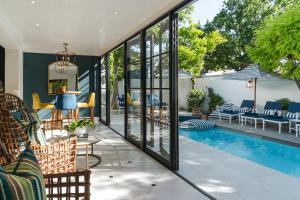 an outdoor patio with a swimming pool and glass walls at Last Word Franschhoek in Franschhoek