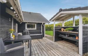 a patio with a table and chairs and a pergola at Gorgeous Home In Hemmet With Wifi in Hemmet